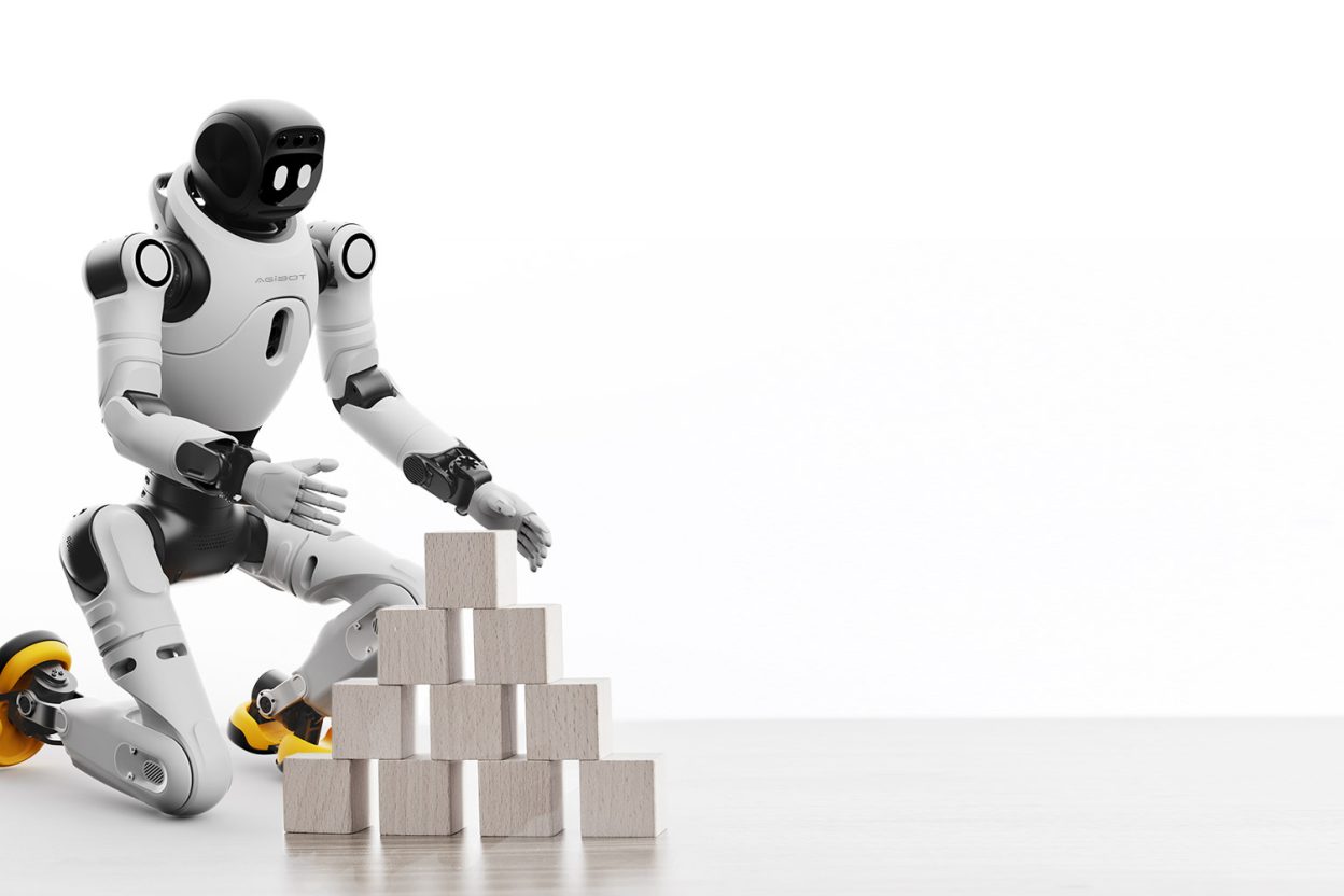 Robot humanoïde AgiBot X2 agenouillé manipulant des blocs en bois empilés en pyramide
