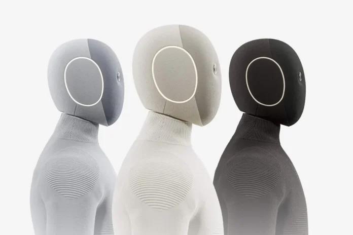1X NEO humanoid robot price: $20,000 to buy or $499 a month on subscription Three 1X NEO humanoid robots shown in grey, beige and black, each with an oval head featuring a circular screen
